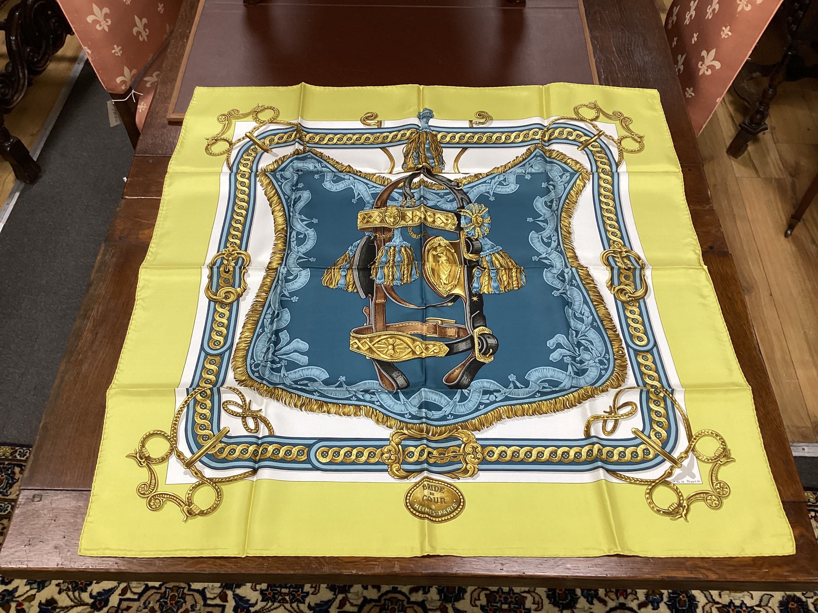 Four vintage Hermes silk scarves comprising Cosmos, Bride de Cour, Roues de Canon and a Cuivreries example retailed by Harrods